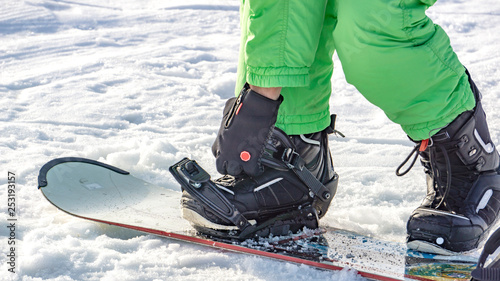 attach the boots to the snowboard. snowboard equipment. hire full snowboarding equipment (snowboards, boots)