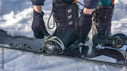 attach the boots to the snowboard. snowboard equipment. hire full snowboarding equipment (snowboards, boots)