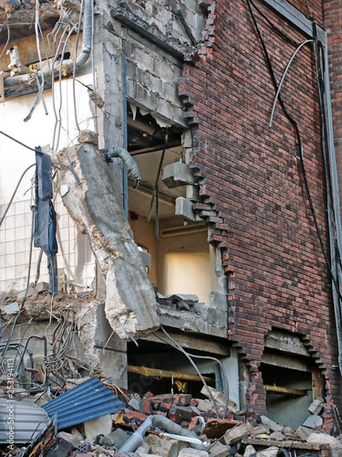 full frame image of a wrecked collapsing building being demolished with smashed brick walls and rubble