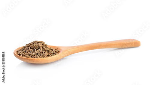 dried cumin seed or caraway in wooden spoon isolated on white background