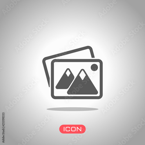 Stack of pictures with couple of mountains and sun. Simple icon. Icon under spotlight. Gray background