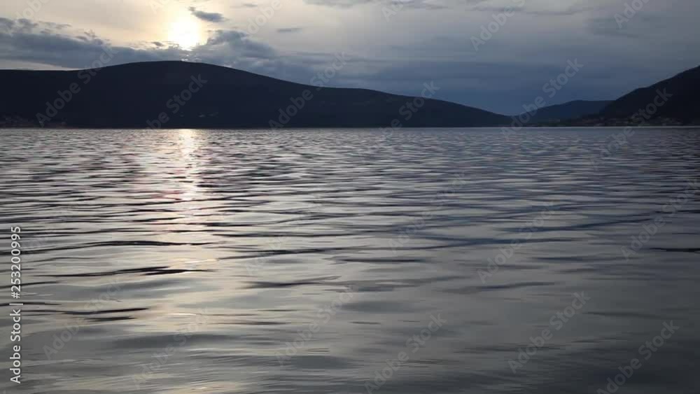 Calm evening background, cloudy sunset over water surface Calm evening background, cloudy sunset over water surface