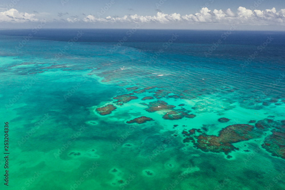 Turquoise water with reef aerial drone