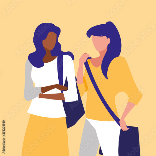 beautiful interracial girls couple modeling with handbag