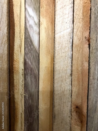 wooden boards of different colors stacked at an angle