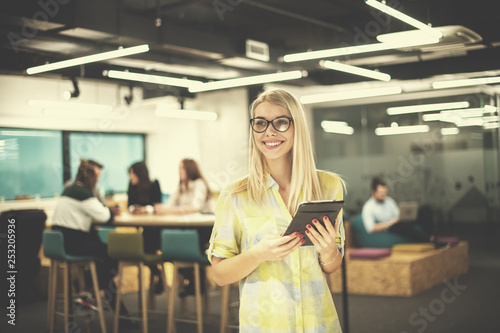 blonde businesswoman working online using digital tablet