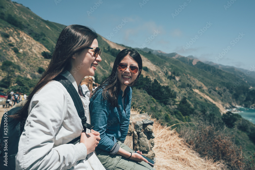 women having fun outdoor hiking trip in big sur