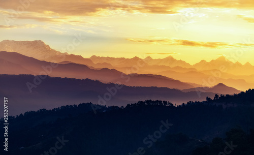 Barren Himalaya mountain ranges at sunrise with moody vibrant sky at Kausani Uttarakhand.