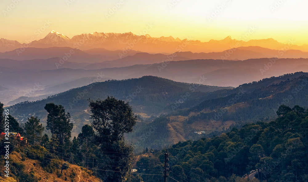 Sunrise at Kausani Uttarakhand India with scenic view of adjacent mountain ranges with Himalaya snow peaks. 