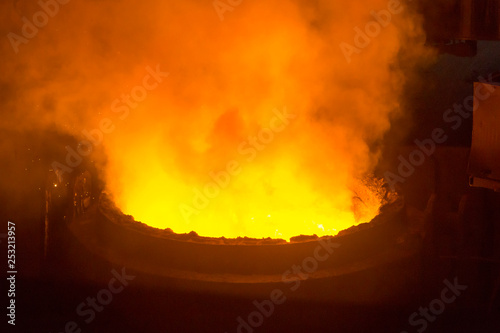 Process of the metal smelting with the martin furnace. Industrial details of metallurgic factory or plant. Details of steel smelting. photo