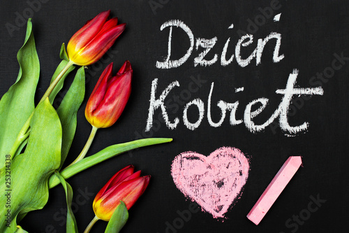 Women's Day card and a bouquet of beautiful tulips on blackboard background, with Polish words "Women's Day"
