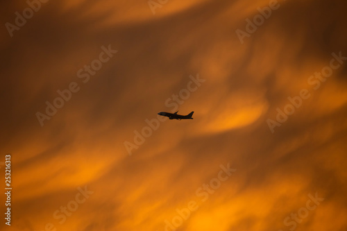 A yellow turbulence cloud with silhouette airplane flying through