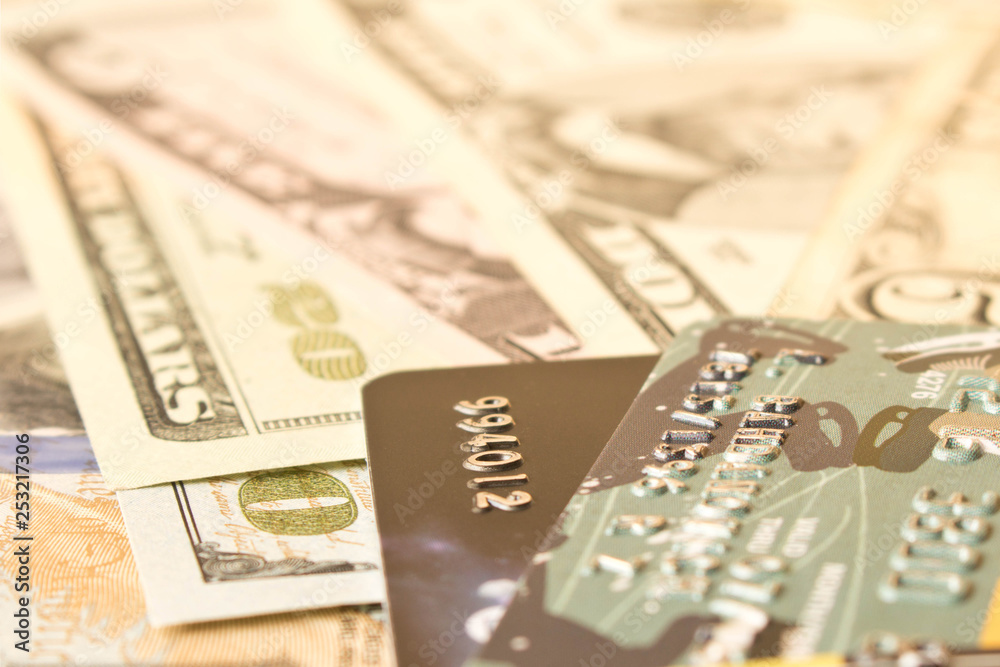 Credit cards and cash dollars. The concept of funding. Selective focus. Credit cards and cash dollars. The concept of funding. Selective focus.