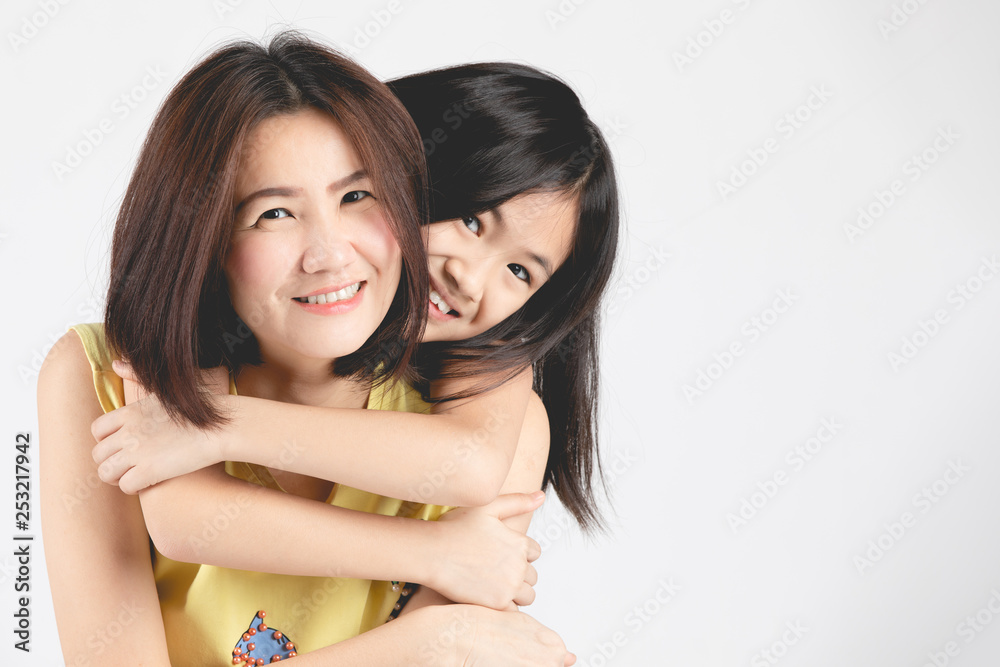 Mother and daughter on gray background . Mother and daughter on gray background .