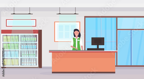 retail woman cashier at checkout counter supermarket saleswoman in uniform shopping concept grocery market interior flat horizontal