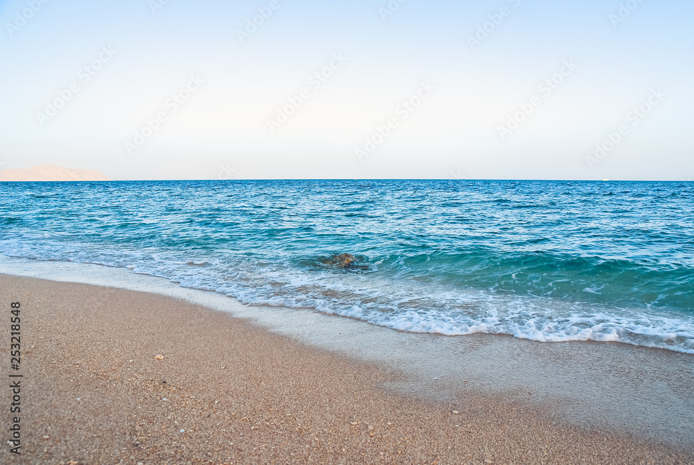 Fototapeta premium yellow warm sand and summer sea with sky and free space. Tropical beach scenery background with copyspace