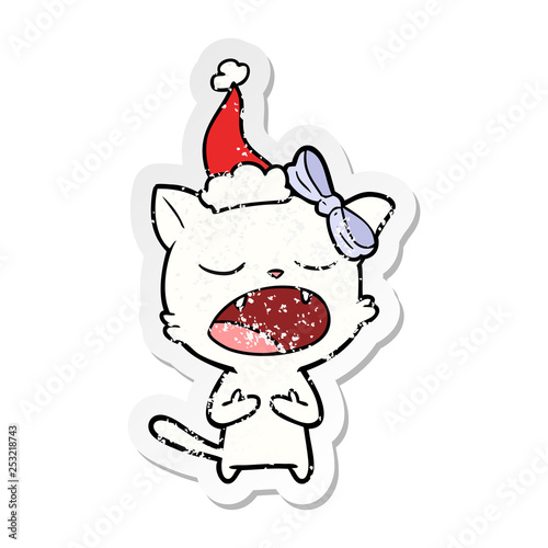 distressed sticker cartoon of a cat meowing wearing santa hat