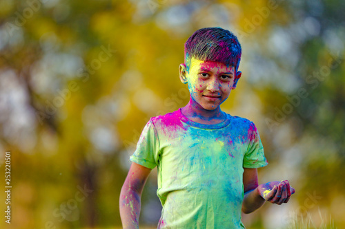 Indian child playing with the color in holi festival