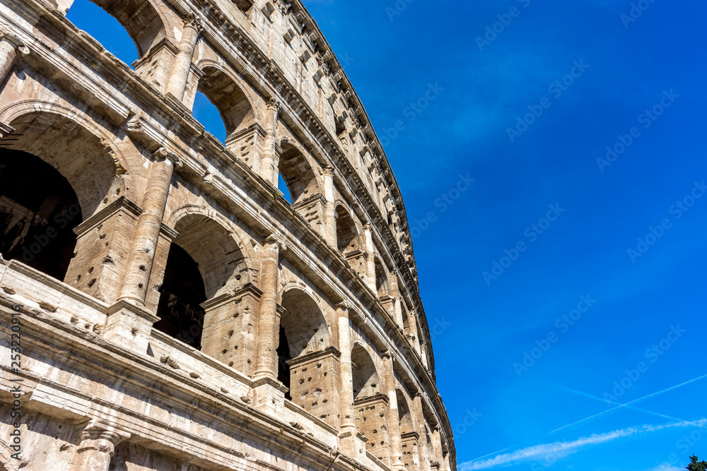 Facade of the Great Roman Colosseum (Coliseum, Colosseo), also known as the Flavian Amphitheatre. Famous world landmark