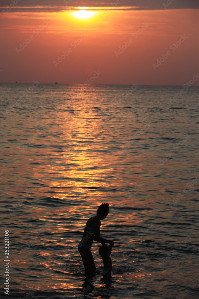 Silhouette of adorable little girl on a beach at sunset Silhouette of adorable little girl on a beach at sunset