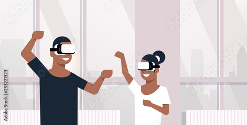 man woman wearing vr glasses african american couple playing virtual reality games dancing together lovers having fun modern apartment interior horizontal portrait
