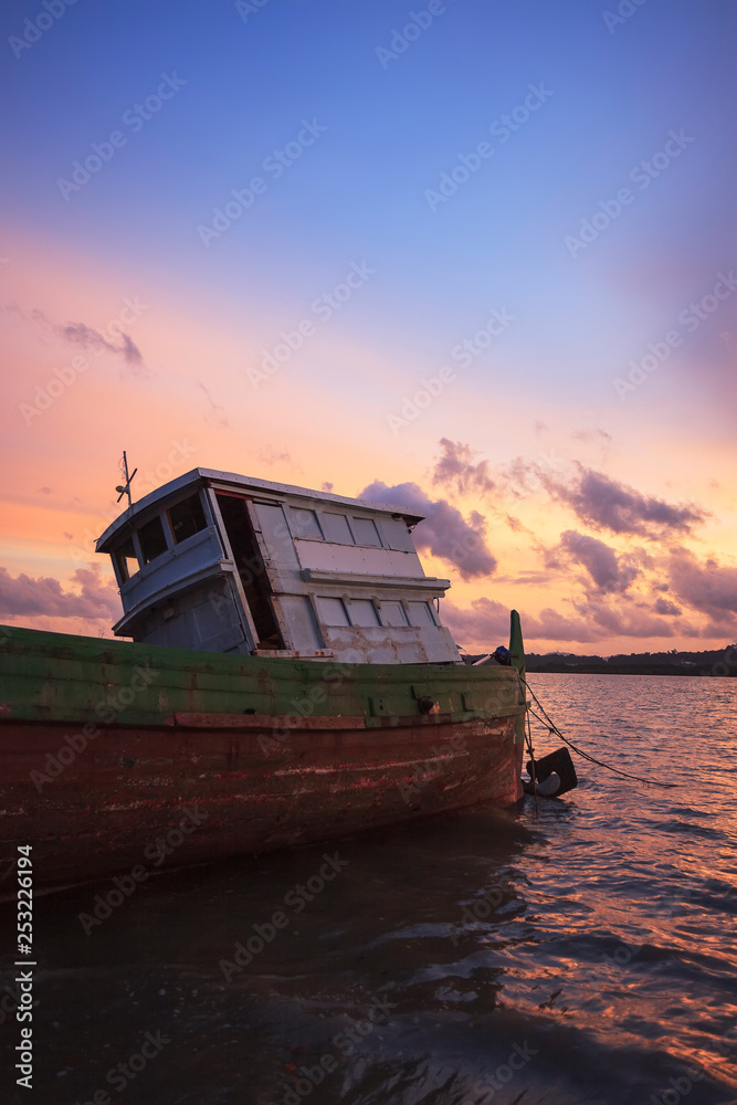 old fishing boat at sunset