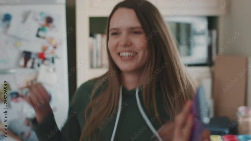 happy teenage girls dancing in kitchen eating pizza having fun celebrating together friend using smartphone sharing celebration on social media enjoying weekend