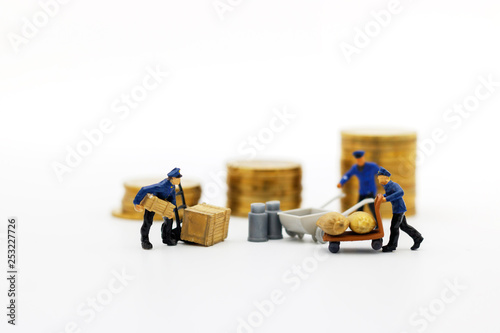 Miniature people: Workers transport coins money. Success, Finance, investment and growth in business concept.
