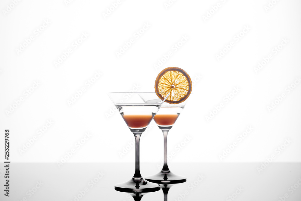 martini glass on a white background with an orange slice. martini glass on a white background with an orange slice.