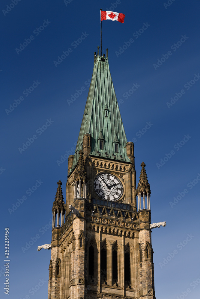 Top of the Peace Tower Parliament Buildings in Ottawa Canada with Canadian flag and clock campanile observation deck and gargoyles