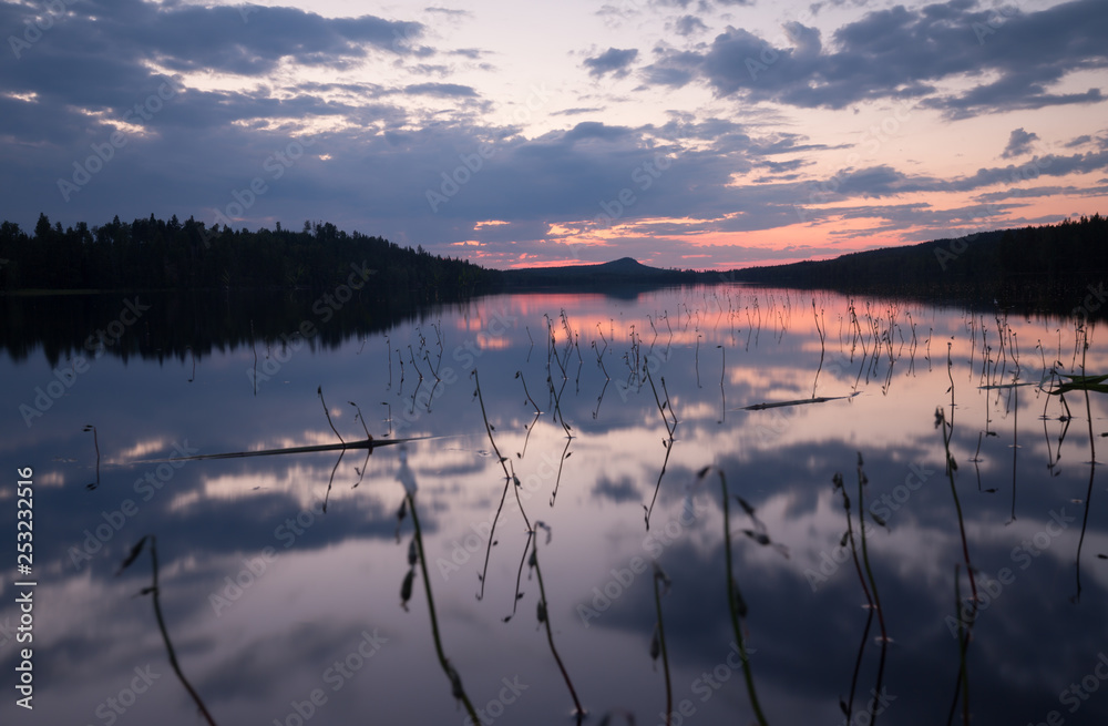 Fototapeta premium Beautiful sunset over a calm lake in summertime