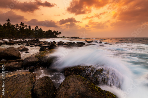 Beautiful sunset on the beach with palms on a Seychelles