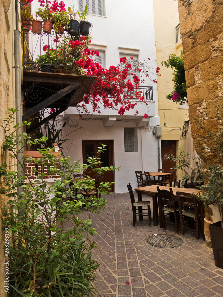 Fototapeta premium Narrow winding street at old venetian harbor of Chania, island of Crete, Greece