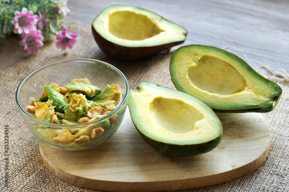 healthy breakfast for diet , avocado mixed with corn flakes, peanuts in glass bowl served on table top healthy breakfast for diet , avocado mixed with corn flakes, peanuts in glass bowl served on table top