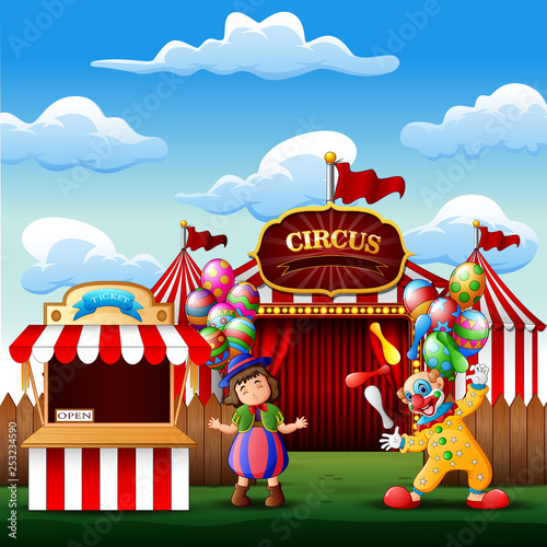 Cute a clown and a girl on the circus entrance