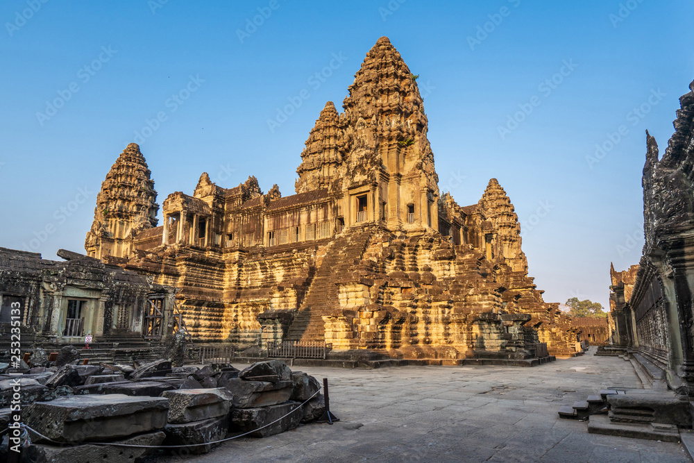 Third level with towers and covered galleries of Angkor Wat temple in golden sunset light