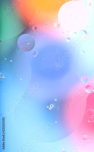 Blurred abstract background. Image of red, blue, green and yellow circles and wavy lines of different sizes. Cropped shot, vertical, abstraction, blurred, free space, no one.