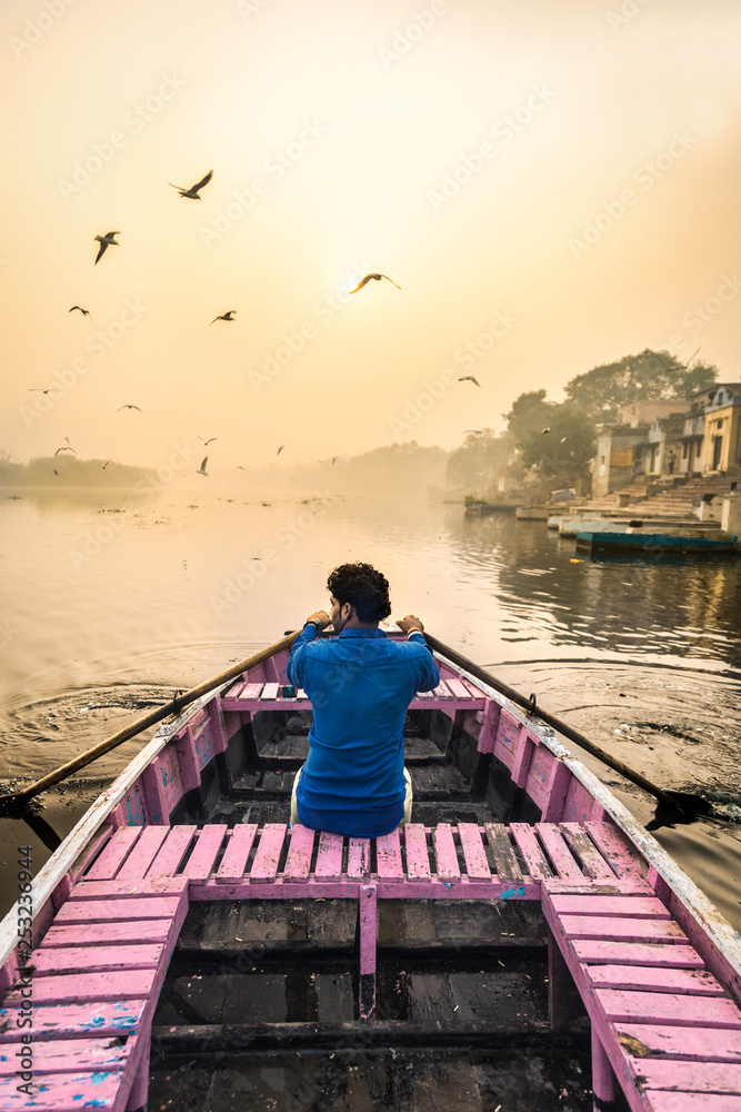 New Delhi, India - November 5 2017 : sunrise at the ghats of Yamuna river with little boat ride to feed the migratory seagulls New Delhi, India - November 5 2017 : sunrise at the ghats of Yamuna river with little boat ride to feed the migratory seagulls