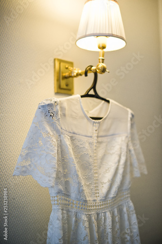 Lace white wedding dress on hanger