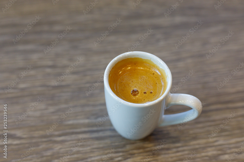 Espresso coffee hot gold in wooden background. Espresso coffee hot gold in wooden background.