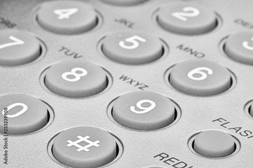 A close up of a Black office IP Phone on a desk A close up of a Black office IP Phone on a desk
