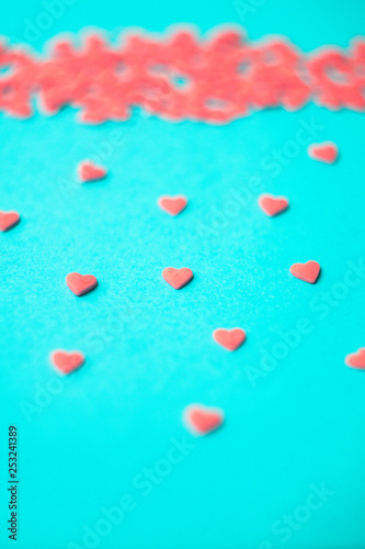 Love concept minimal. Sweet sugar hearts on a colored background. Contemporary art design, abstract minimalism.