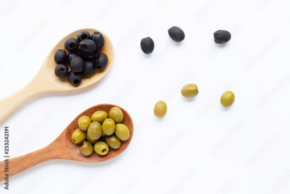 Olives on wooden spoon, white background. Olives on wooden spoon, white background.