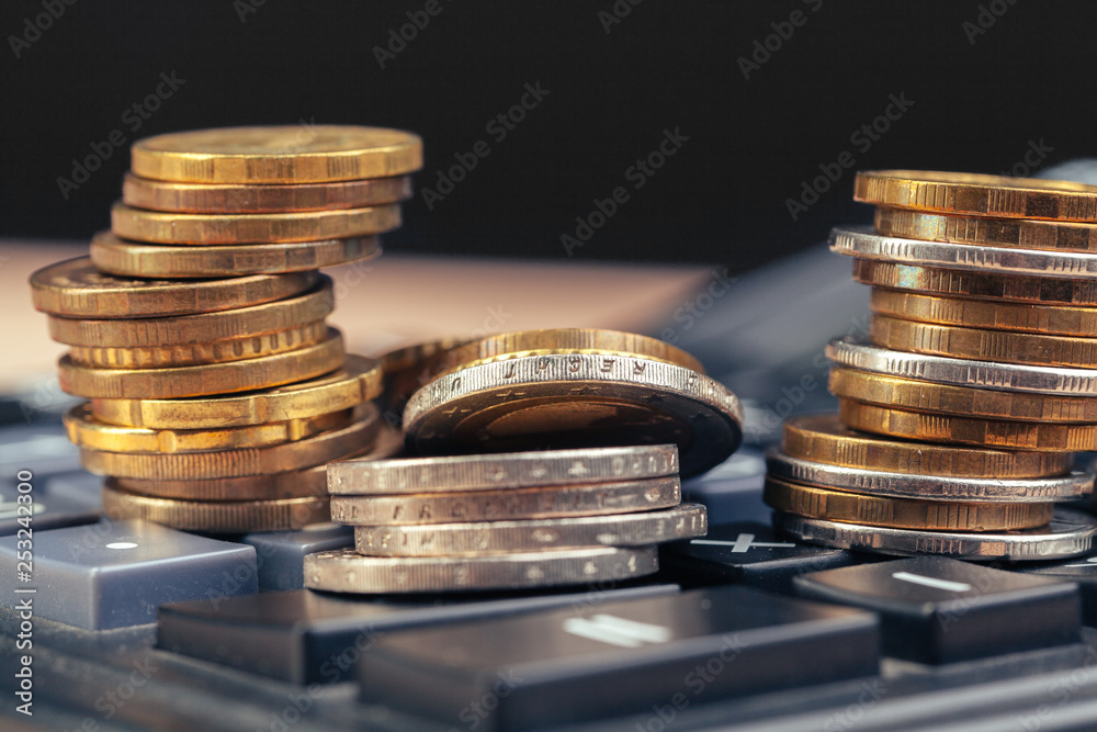 stack of coins and calculator,concept idea for business finance stack of coins and calculator,concept idea for business finance