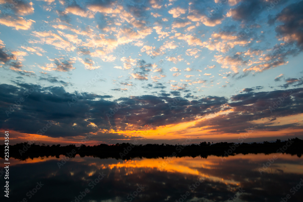 colorful dramatic sky with cloud at sunset.