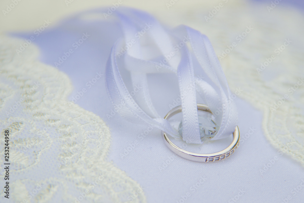 Wedding ring with the white soft ribbon on the pillow Wedding ring with the white soft ribbon on the pillow