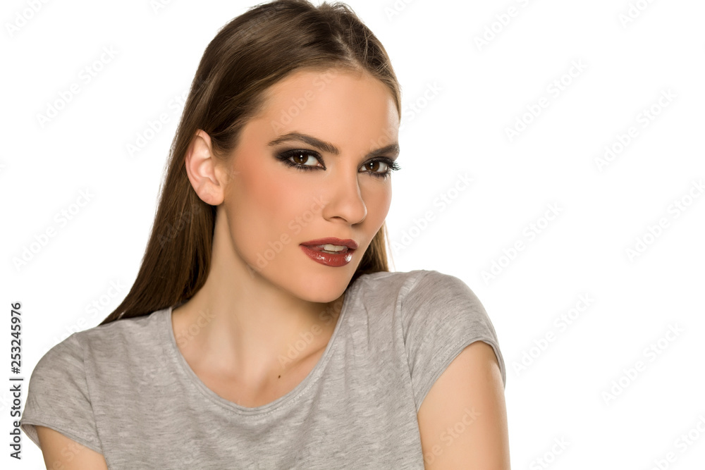 Young woman with makeup, posing on white background Young woman with makeup, posing on white background
