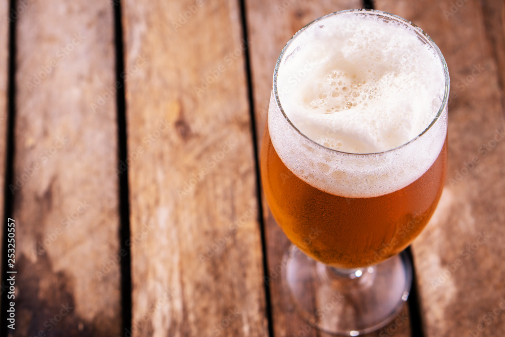 Cold beer into a glass with foam. Cold beer into a glass with foam.