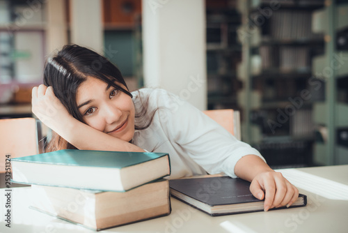 Young Asian woman with the books at library  vintage tone