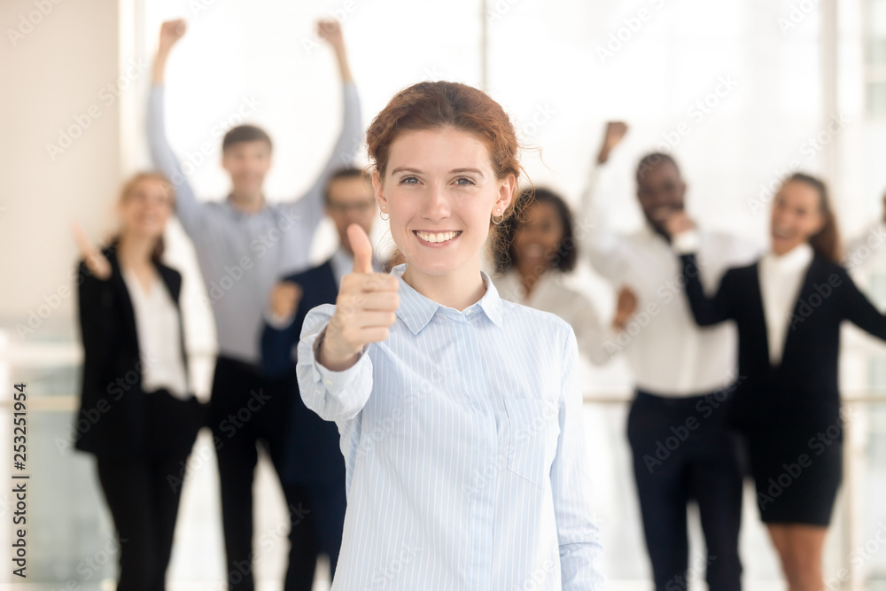 Client showing thumbs up satisfied with service employees on background Client showing thumbs up satisfied with service employees on background